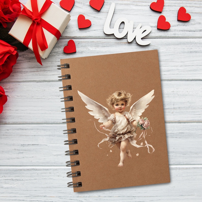 May include: A spiral-bound notebook with a brown cover featuring a vintage illustration of a cherub holding flowers. The word "Love" is spelled out in white letters. Red hearts and a gift box with a red ribbon are also visible.