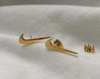 Gold nike swoosh 2025