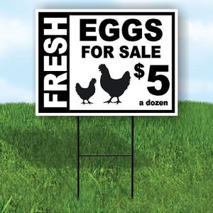 May include: A black and white sign with the text "FRESH EGGS FOR SALE $5 a dozen". The sign has a silhouette of two chickens.