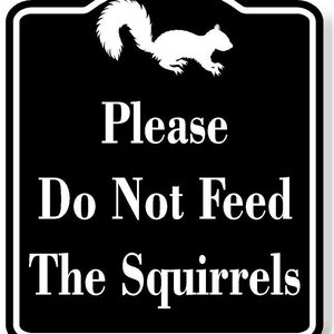 May include: Black and white sign with a white silhouette of a squirrel. The sign reads "Please Do Not Feed The Squirrels".