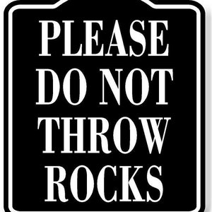 May include: Black and white sign with the text "PLEASE DO NOT THROW ROCKS" in a white sans-serif font.
