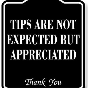 May include: Black and white sign with rounded corners that reads "Tips are not expected but appreciated. Thank you".