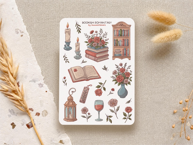 Bookish Romantasy cottagecore sticker sheet featuring pile of books with flowers, open book, lantern, vase with flowers, shelf full of books, single floral stickers, and glass of wine, with dreamy book lover aesthetic.