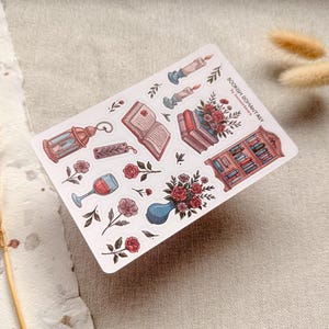 Bookish Romantasy cottagecore sticker sheet featuring pile of books with flowers, open book, lantern, vase with flowers, shelf full of books, single floral stickers, and glass of wine, with dreamy book lover aesthetic.