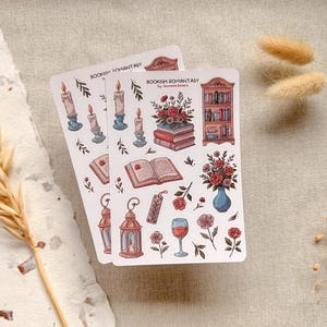 Bookish Romantasy cottagecore sticker sheet featuring pile of books with flowers, open book, lantern, vase with flowers, shelf full of books, single floral stickers, and glass of wine, with dreamy book lover aesthetic.