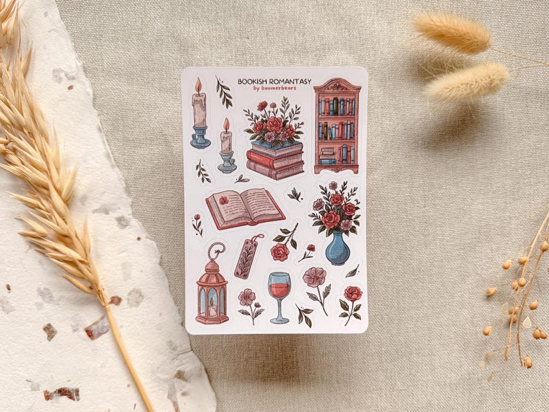 Bookish Romantasy cottagecore sticker sheet featuring pile of books with flowers, open book, lantern, vase with flowers, shelf full of books, single floral stickers, and glass of wine, with dreamy book lover aesthetic.