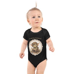 May include: Black baby bodysuit with a whimsical illustration of a cartoon elf holding a key, framed by a decorative border. The text "Accidentally mischievous" is above the illustration. The bodysuit is short-sleeved.