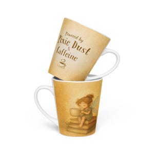 May include: Two white latte mugs. One mug has the text "Powered by Pixie Dust & Caffeine" on a tan background. The other mug features a fairy sitting on books, holding a cup, with a tan background.