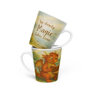 May include: Two white ceramic mugs stacked. The top mug has the text "Sip slowly Magic takes Time" on a light blue and yellow background. The bottom mug features a cartoon dragon reading a book, with a green and yellow background.