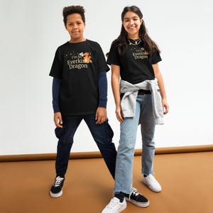 May include: Two people wearing black t-shirts with the text "I'm An Everkind Dragon" in gold lettering and a small dragon graphic. The person on the left is wearing a long-sleeved blue shirt underneath. The person on the right is wearing blue jeans.