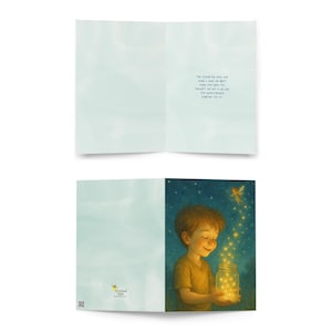 May include: Greeting card featuring a boy holding a jar filled with glowing lights, with a fairy above. The card is open, revealing a light blue interior and a poem. The card's theme is whimsical and magical.