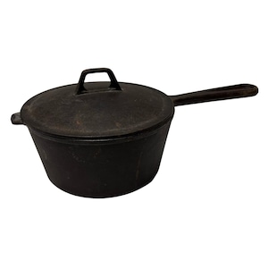 May include: A black cast iron pot with a lid and a long handle. The pot has a rounded shape with a flat bottom and a handle on the lid. The handle is a loop shape.