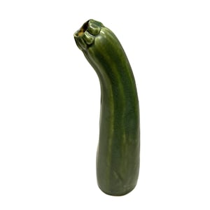 May include: A tall, curved ceramic vase with a glossy dark green glaze. The vase features a cylindrical body that tapers slightly towards the top, mimicking the organic shape of a courgette, with a textured, scalloped rim at the opening.