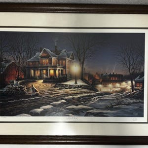 May include: A framed print of a winter scene with a large house, a street lamp, and a wolf in the foreground. The house is lit up with warm light, and the snow is falling softly. The print is titled "Gallop of Hope" and is signed by the artist.