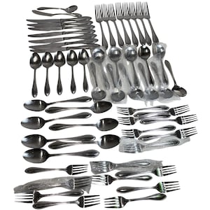 May include: A collection of stainless steel silverware, including forks, spoons, and knives. The utensils are arranged in stacks and bundles, some still in plastic wrapping. The silverware has a shiny, reflective surface.