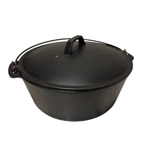 May include: A black cast iron Dutch oven with a lid and handle. The pot has a rounded shape and a wire handle for carrying. The lid has a handle for easy removal. This cookware is ideal for camping and outdoor cooking.