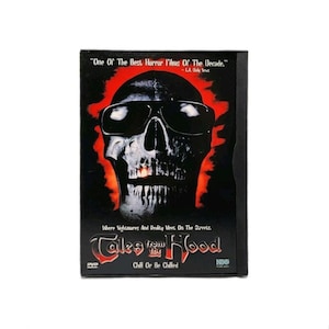 May include: A DVD case for the film Tales from the Hood, featuring a black and white skull wearing sunglasses against a red background. The cover includes the text One Of The Best Horror Films Of The Decade, Where Nightmares And Reality Meet, On The Streets, and Chill Or Be Chilled.