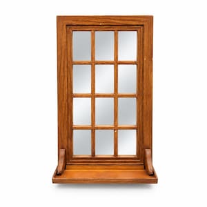 May include: A rectangular wall mirror featuring a medium-toned wooden frame designed to resemble a window with twelve individual panes. The mirror includes a small, attached wooden shelf at the base, supported by two curved wooden brackets.