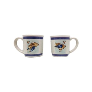 May include: Two white ceramic mugs with a blue rim and handle. Each mug features a cartoon rabbit in a blue jacket and a butterfly. The mugs are likely part of a set and are suitable for hot beverages.