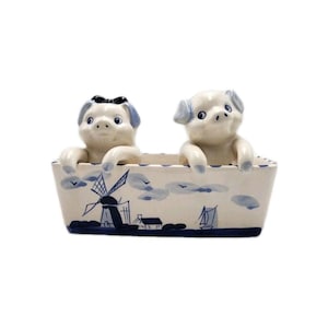 May include: A white ceramic mug with a black handle and the text "But First, Coffee" in a black, bold font. The mug is likely 11 ounces in size and sits on a white surface.