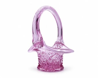 May include: A translucent light purple glass basket featuring a textured diamond pattern on the exterior of the bowl and a smooth, arched handle. The rim of the basket flares outward, and the base is circular with a flat bottom surface.
