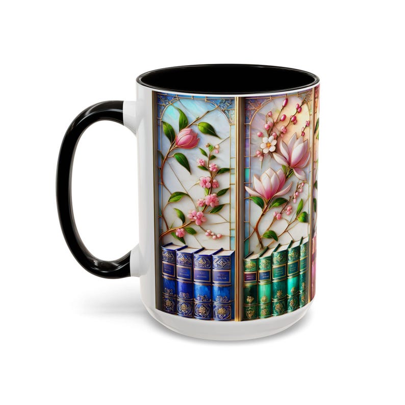 May include: White ceramic mug with a black handle and interior. The mug features a stained-glass design with pink flowers, green leaves, and a stack of books. The design wraps around the mug.