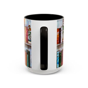 May include: White ceramic mug with a black interior and handle. The mug features a colourful design of books on shelves, with a variety of book colours. The design wraps around the mug, creating a decorative and artistic look. The mug is suitable for hot or cold beverages.