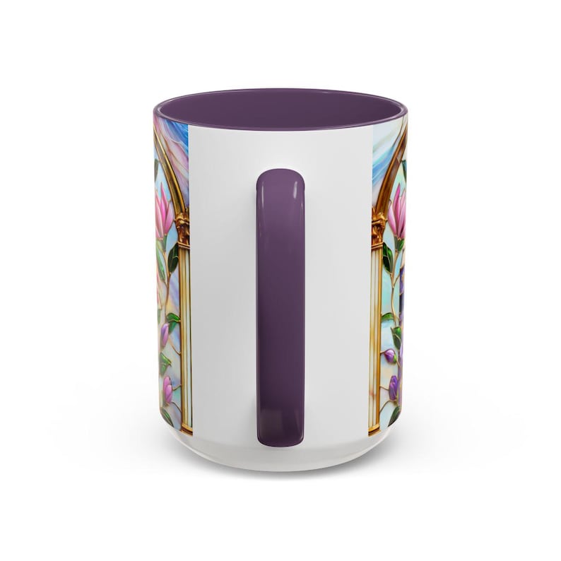 May include: White ceramic mug with a purple interior and handle. The mug features a stained-glass design with pink and purple flowers, gold trim, and a blue sky background. The handle is a solid purple color.