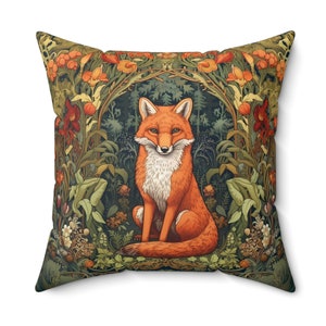 This William Morris inspired pillow features an orange fox facing forward, sitting, surrounded by lush foliage punctuated by orange and red flowers.  This design is intricate and pillow cover is a luxurious faux suede texture.
