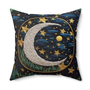 May include: A decorative throw pillow with a dark blue background featuring a white crescent moon and gold stars. The moon is surrounded by a gold circle with a green grass-like design at the bottom.