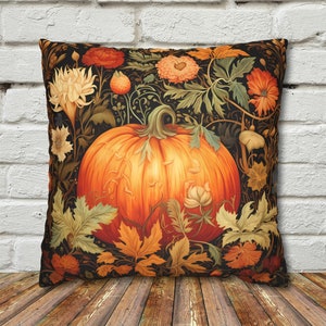 May include: A throw pillow with a dark background featuring a large orange pumpkin surrounded by fall foliage and flowers. The pumpkin is in the center of the design and is surrounded by leaves, flowers, and vines in shades of green, brown, and orange.
