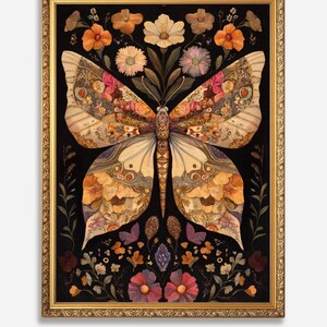 May include: A framed artwork featuring a large butterfly made of pressed flowers and leaves. The butterfly is in shades of brown, yellow, and white, with accents of pink and purple. The background is black, and the frame is gold.