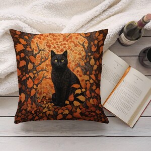 May include: A black cat with yellow eyes sits in a pile of orange and brown autumn leaves. The cat is looking directly at the viewer. The background is a dark forest.