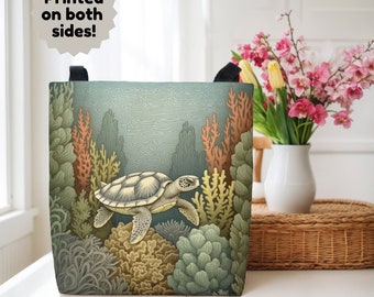 May include: A tote bag with a sea turtle swimming through a coral reef. The bag is printed with a detailed illustration of the turtle and coral. The text "Printed on both sides!" is printed on the top of the bag.