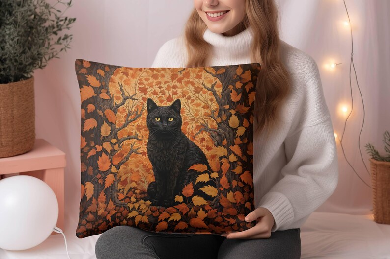May include: A black cat with yellow eyes sits in a forest of orange and brown leaves. The cat is surrounded by leaves and branches. The background is a blurred image of a forest.