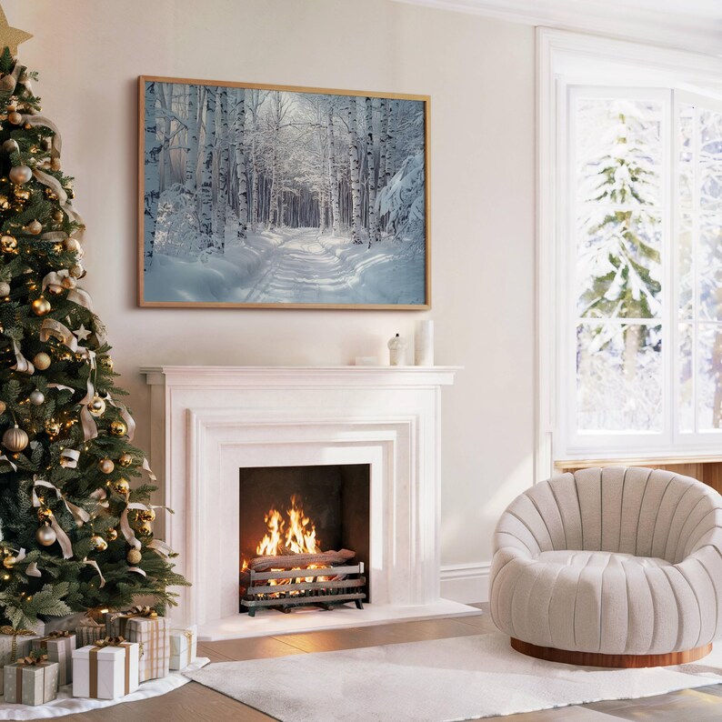Puede incluir: Un cuadro enmarcado con una escena invernal de un bosque de abedules nevado, colgado sobre una chimenea blanca con fuego. Un &aacute;rbol de Navidad decorado y un sill&oacute;n c&oacute;modo tambi&eacute;n son visibles, creando un ambiente c&aacute;lido y acogedor.