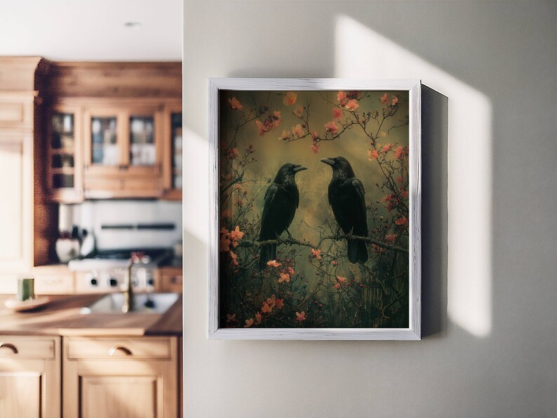 May include: A framed print of two black ravens perched on branches with pink blossoms. The background is a soft, muted green and brown.