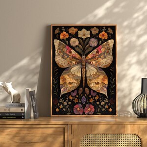 May include: A framed print of a butterfly with wings made of dried flowers and leaves on a black background. The butterfly is surrounded by smaller flowers and leaves.