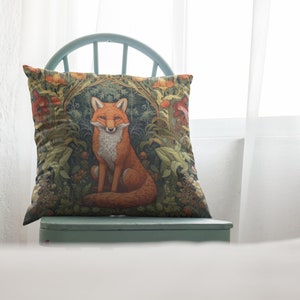 May include: A green chair with a throw pillow featuring a fox sitting in a forest scene. The pillow has a floral pattern with red, orange, and yellow flowers.