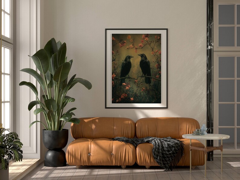 May include: A framed print of two black crows perched on branches with pink blossoms. The background is a soft, muted green and brown.