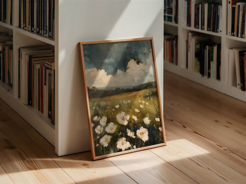 May include: A framed painting of a field of white flowers with a blue sky and white clouds in the background.