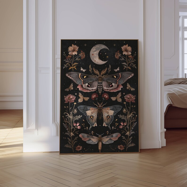 May include: A black and gold framed print with a dark background featuring a crescent moon and three moths with floral accents. The moths are in shades of brown, gray, and white.