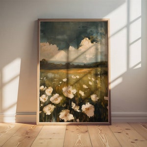 May include: A framed painting of a field of white flowers with a blue and green sky in the background.