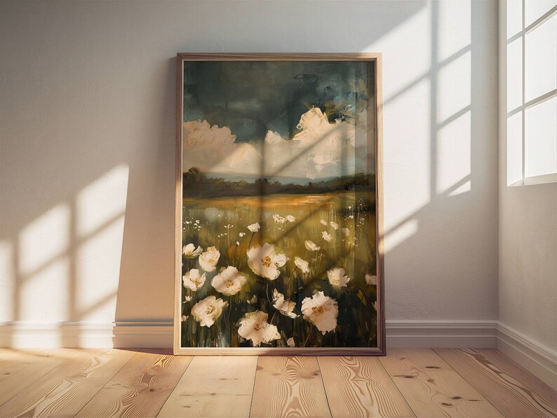 May include: A framed painting of a field of white flowers with a blue and green sky in the background.