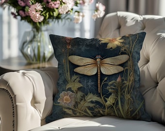 May include: A decorative cushion with a dark blue background featuring a detailed illustration of a dragonfly with yellow and brown wings, surrounded by green and yellow floral elements.