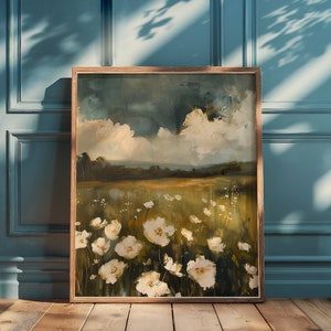 May include: A framed painting of a field of white flowers with a blue and white cloudy sky in the background.