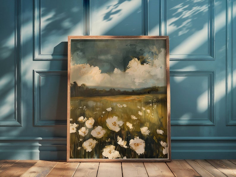 May include: A framed painting of a field of white flowers with a blue and white cloudy sky in the background.