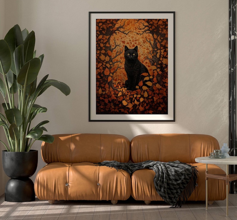 This gorgeous poster features a William Morris inspired black vat facing the camera, staring with yellow eyes. The sitting cat is nestled in vibrant fall leaves and framed in black branches.