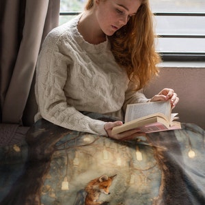 This beautiful Walter Crane inspired sherpa fleece blanket depicts an illustration of a fox reading at night in the forest surrounded by little lights.  The fox has a blue blanket draped over his back.