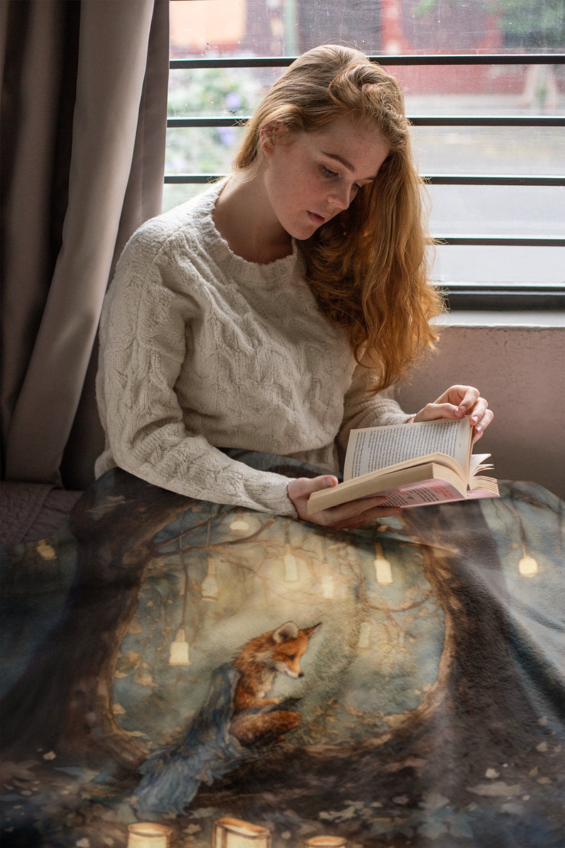 This beautiful Walter Crane inspired sherpa fleece blanket depicts an illustration of a fox reading at night in the forest surrounded by little lights.  The fox has a blue blanket draped over his back.